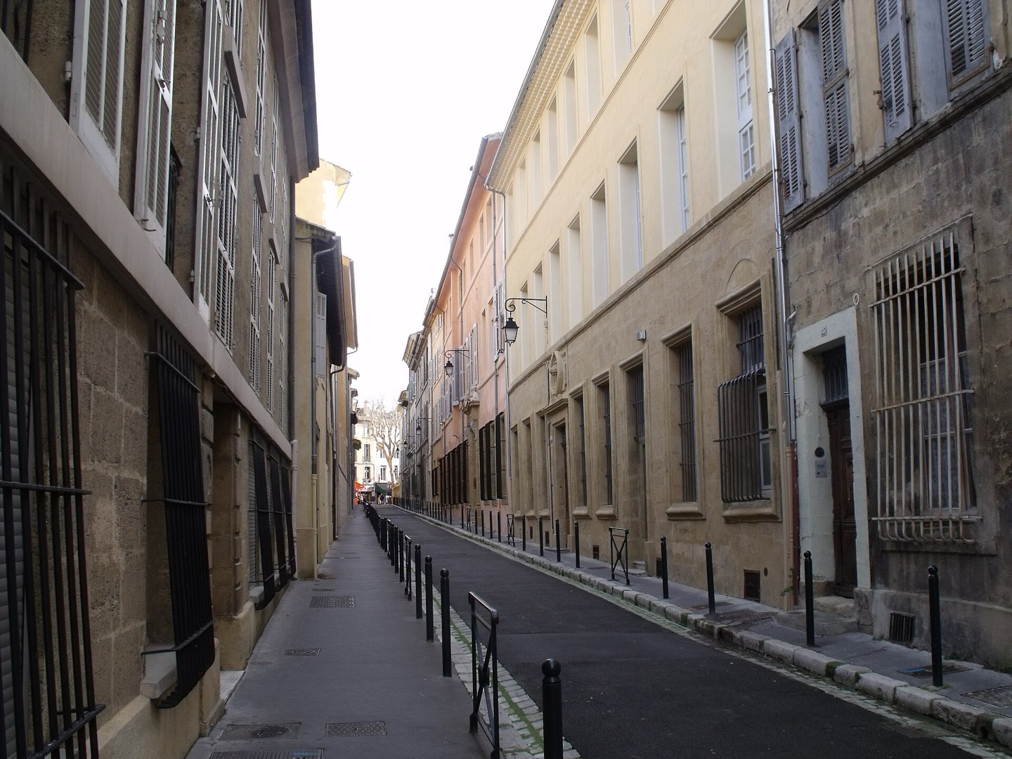 Rue Roux-Alpheran in Aix-en-Provence with historic facades, shutters, and a narrow street.